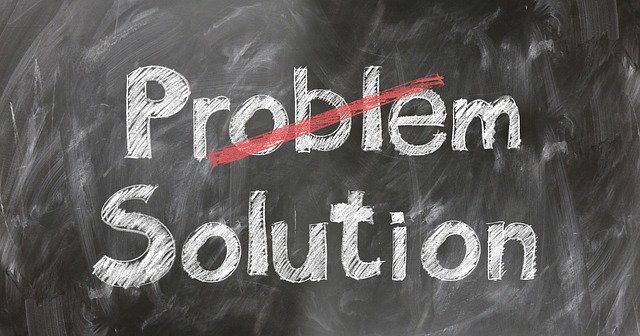 A chalkboard with the word problem crossed out and the word solution under it to emphasize marketing solutions
